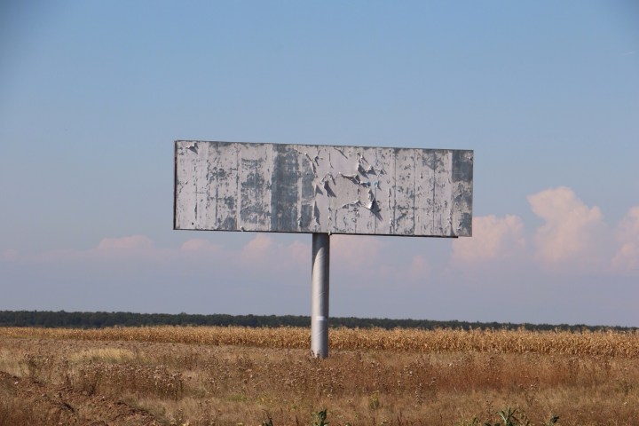 Romania empty billboard in front of corn fields. Crank and Cog cycle tour of Romania.