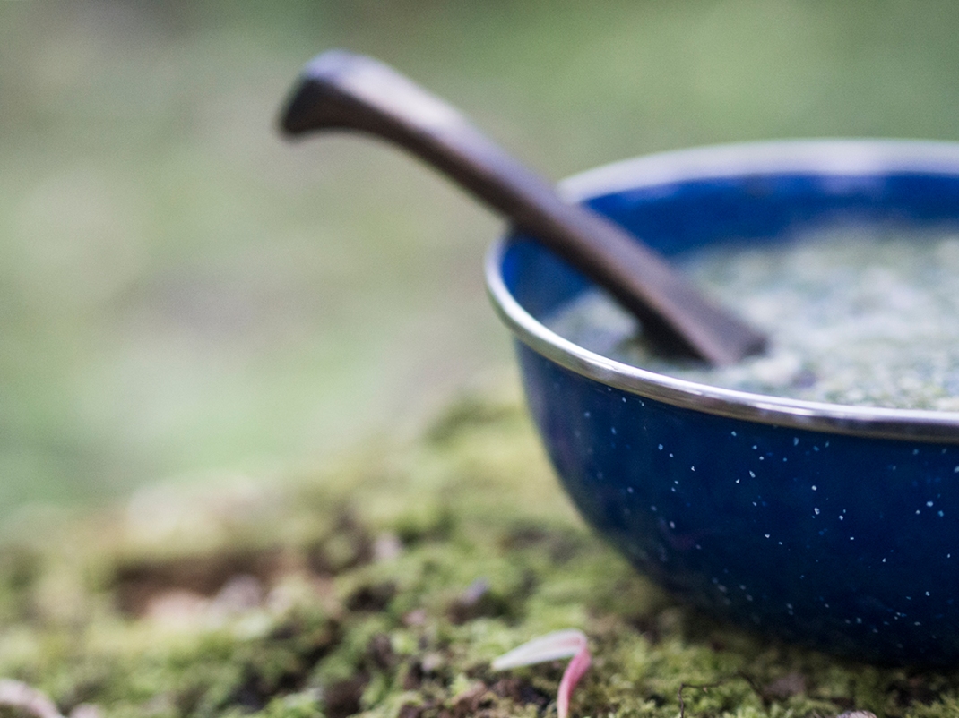 A ceramic bowl of nettle gruel | Wild cooking with Crank and Cog.