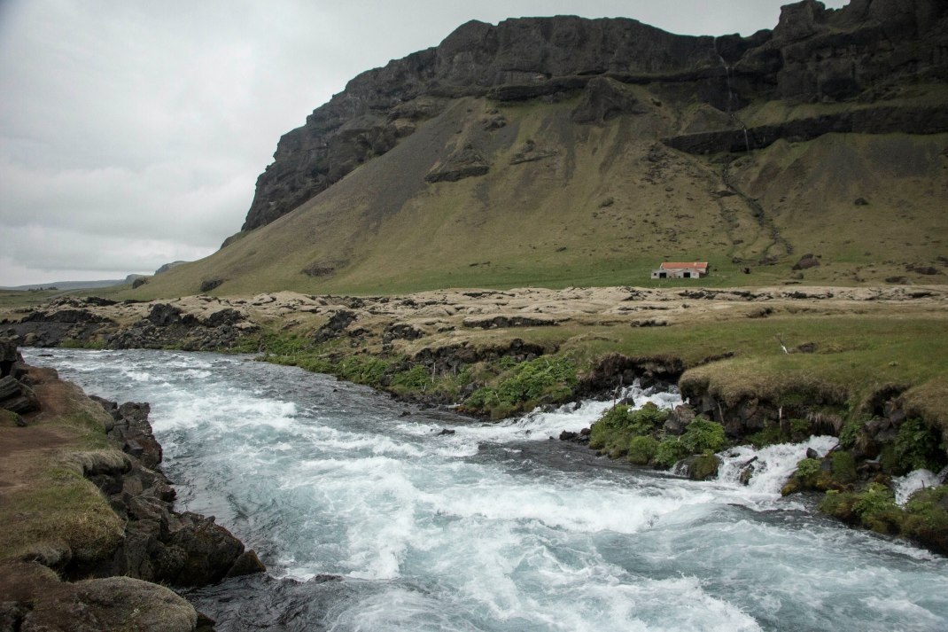 Icelandic stream at the foot of a mountain | Crank & Cog cycle tour of Iceland.